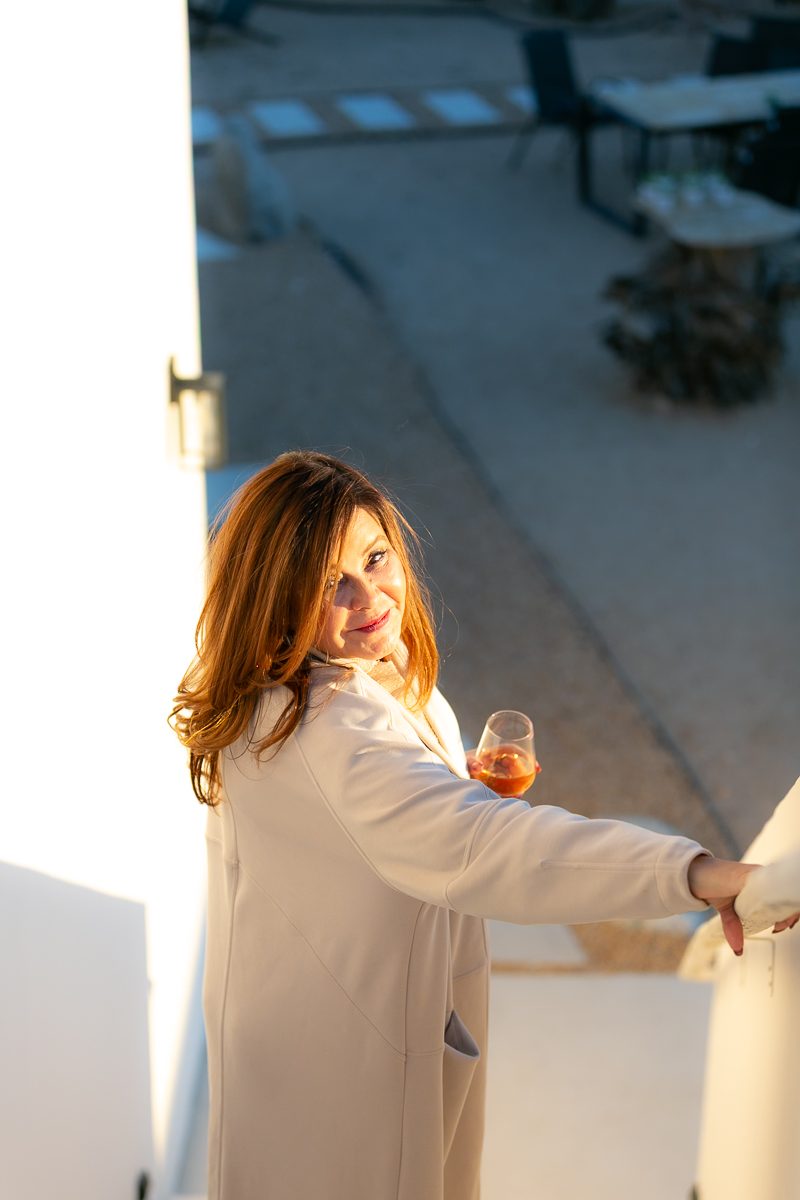 Founder enjoying a glass of wine at sunset